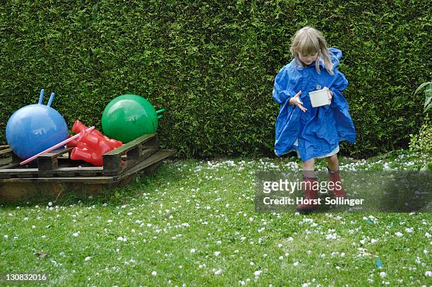 blonde girl, 6 years old, collecting hailstones after a storm, 11.8.2008, nicklheim, bavaria, germany, europe - bavaria girl stockfoto's en -beelden