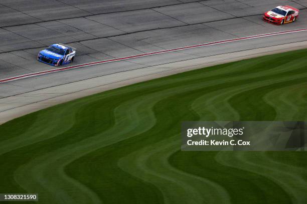 Kyle Larson, driver of the HendrickCars.com Chevrolet, leads Ryan Blaney, driver of the BodyArmor Ford, during the NASCAR Cup Series Folds of Honor...