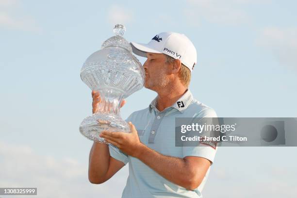 Matt Jones of Australia celebrates with the trophy after winning during the final round of The Honda Classic at PGA National Champion course on March...