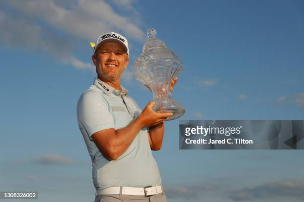 Matt Jones of Australia celebrates with the trophy after winning during the final round of The Honda Classic at PGA National Champion course on March...