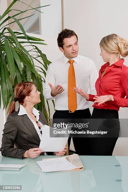 argument at the office, workplace fight, arguing, three coworkers fighting at work - dissent collar stock pictures, royalty-free photos & images