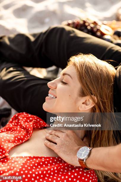 couple embracing and kissing on sandy beach near ocean. - man in dress foto e immagini stock