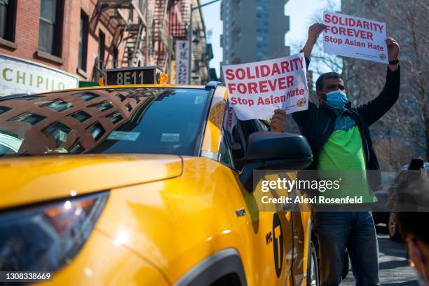 Taxi drivers hold "solidarity forever, stop asian hate" outside the "Rally Against Hate" in Chinatown on March 21, 2021 in New York City. Stop Asian...