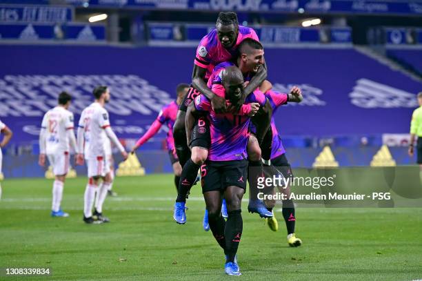 Danilo of Paris Saint-Germain is congratulated by teammates Moise Kean and Marco Verratti after scoring during the Ligue 1 match between Olympique...
