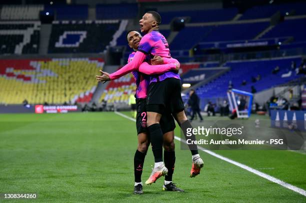 Kylian Mbappe of Paris Saint-Germain is congratulated by teammate Abdou Diallo after scoring during the Ligue 1 match between Olympique Lyon and...