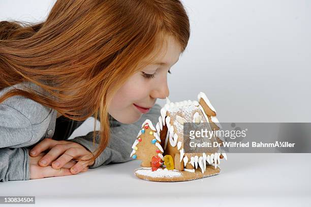 girl with her gingerbread house, christmas cookies - smelling food stock pictures, royalty-free photos & images