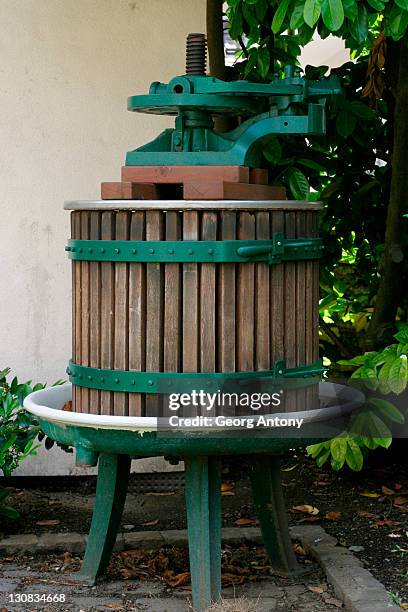 old grapes squeezer extractor press - wooden wine press stock pictures, royalty-free photos & images
