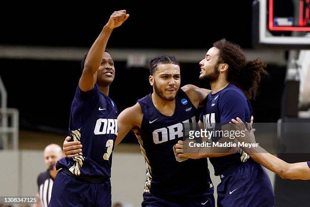 Max Abmas, Kevin Obanor and Kareem Thompson of the Oral Roberts Golden Eagles celebrate after defeating the Florida Gators in the second round game...