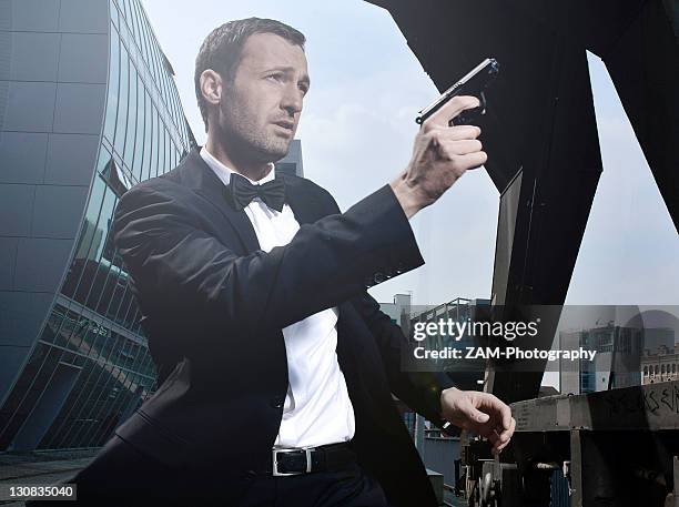 31-year-old man dressed up as james bond in duesseldorf harbour, north rhine-westphalia, germany, europe - secret agent stock-fotos und bilder