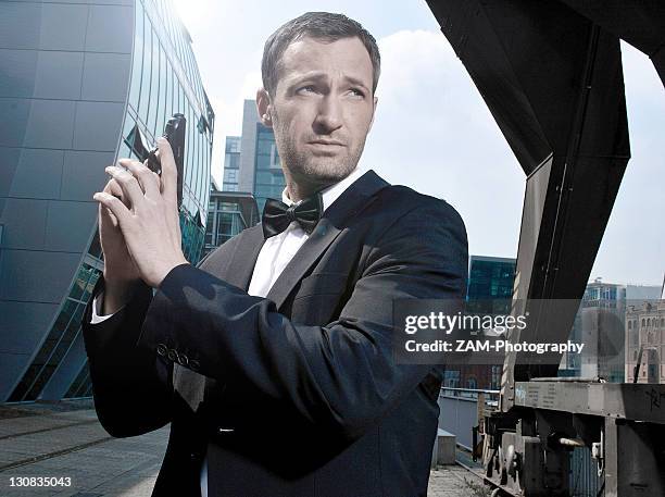 31-year-old man dressed up as james bond in duesseldorf harbour, north rhine-westphalia, germany, europe - secret agent stock-fotos und bilder