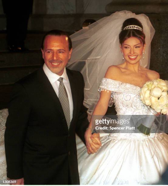 Mexican actress and singer Thalia and husband Tommy Mattola smile to the crowd after their marriage ceremony December 2, 2000 in New York City.