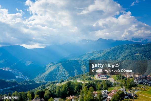 summer aerial view of the ski resort rosa khutor. a complex of hotels on the site of the former olympic village of rosa plateau at an altitude of 1170 m from sea level. krasnaya polyana, sochi, russia - krasnodar stock-fotos und bilder