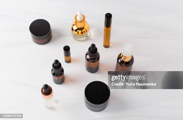 glass cosmetic bottle on light background - painting art product stock pictures, royalty-free photos & images