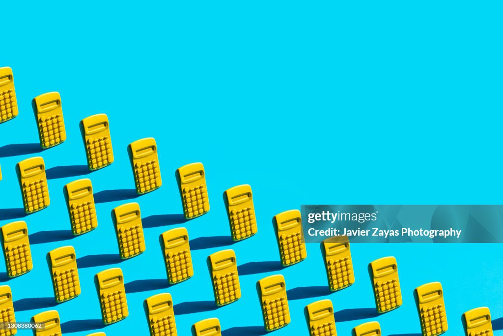 Some Yellow Calculators On Blue Background