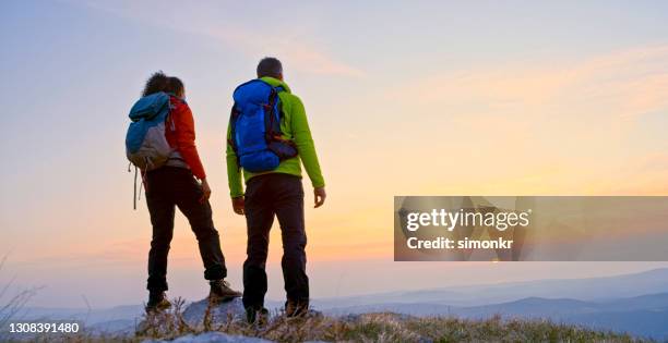 rear view of mature couple standing on mountain - shoes top view stock pictures, royalty-free photos & images