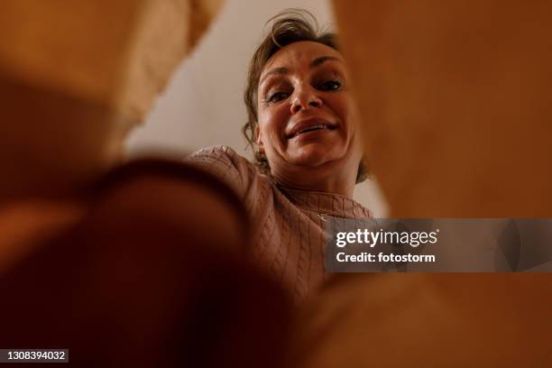 personal perspective shot of woman unpacking take out food from a paper bag - perspective stock pictures, royalty-free photos & images