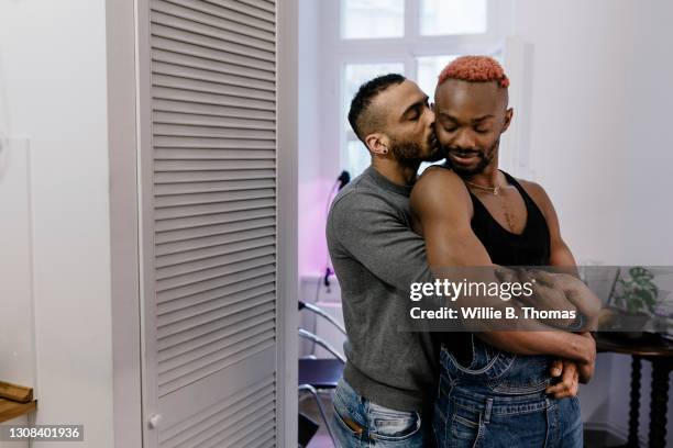 gay couple hugging after meeting on dating app - der kuss stock-fotos und bilder