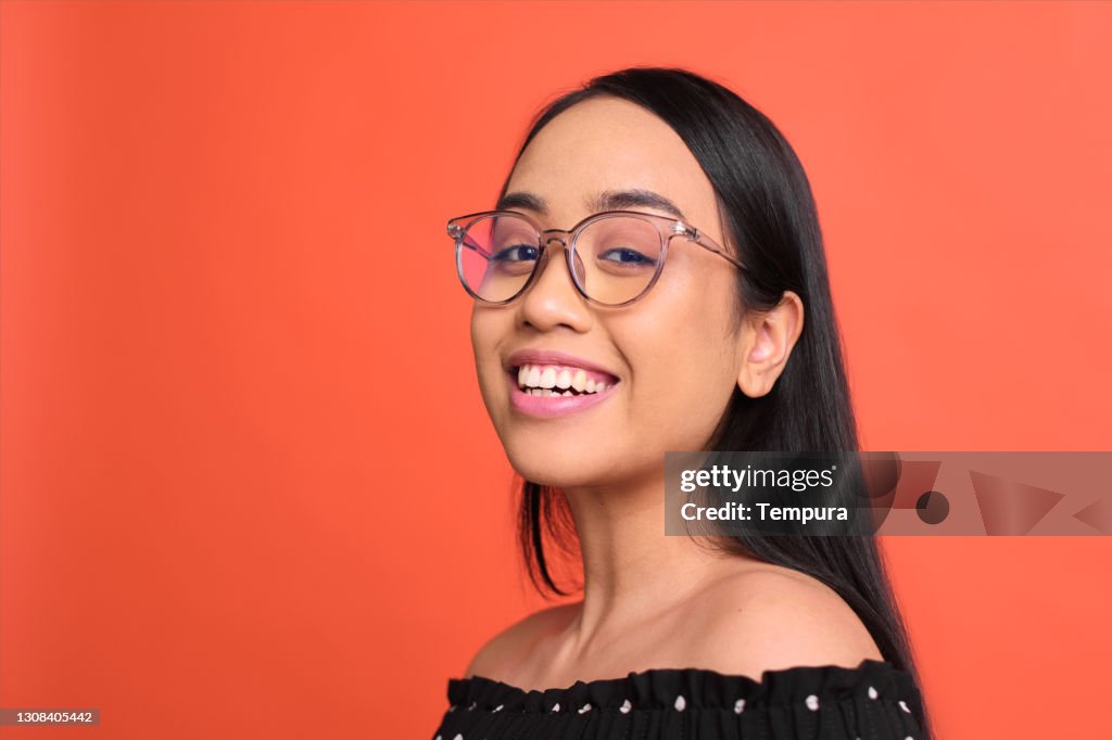 Studio portrait of a young Filipino woman.