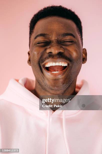 nothing but smiles here - happy man pink background stock pictures, royalty-free photos & images