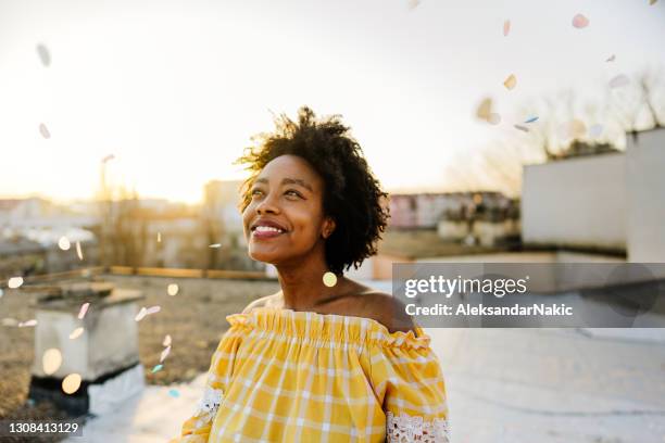 beautiful day on the rooftop - african woman smiling stock pictures, royalty-free photos & images