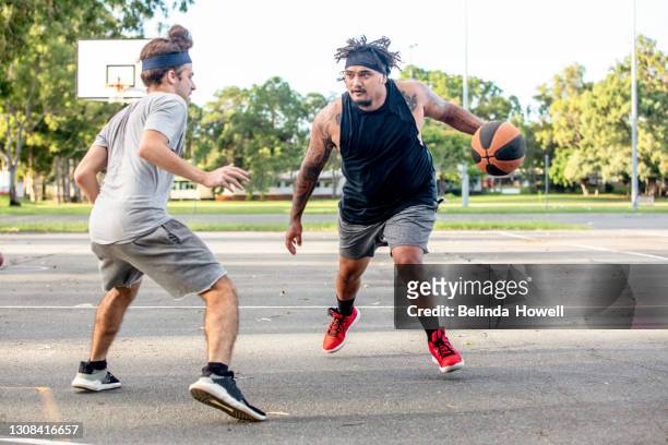 group of young men play basketball at the local courts - australian basketball challenge imagens e fotografias de stock