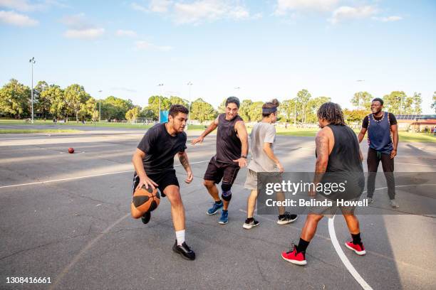 group of young men play basketball at the local courts - australian basketball challenge imagens e fotografias de stock