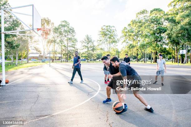 group of young men play basketball at the local courts - athletics australia stock-fotos und bilder