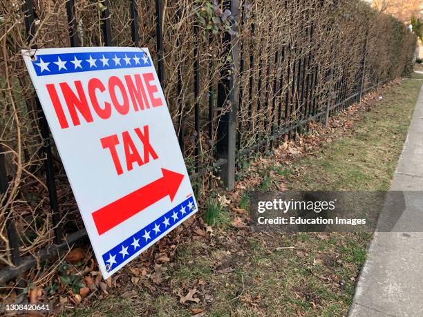 Income Tax sign on sidewalk, Forest Hills, Queens, New York.