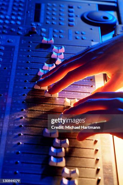 hands of a sound engineer adjusting the regulators of a professional mixer unit - various angles stock pictures, royalty-free photos & images