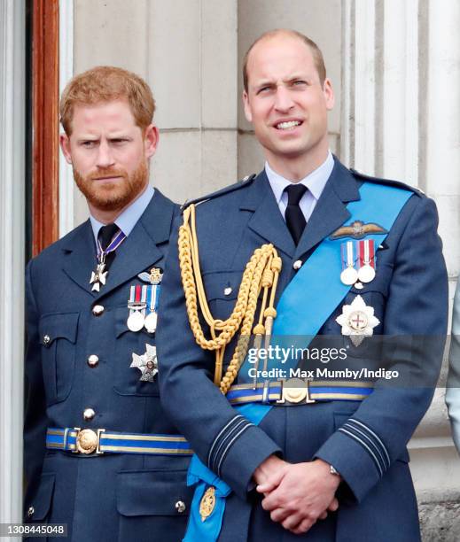 Prince Harry, Duke of Sussex and Prince William, Duke of Cambridge watch a flypast to mark the centenary of the Royal Air Force from the balcony of...