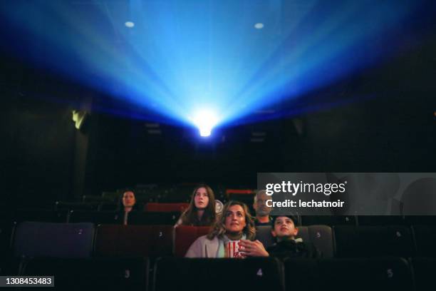 audience in the cinema - film projector stock pictures, royalty-free photos & images
