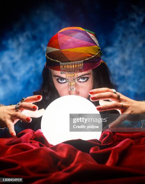 fortune teller with glowing crystal ball - wizard woman stock pictures, royalty-free photos & images