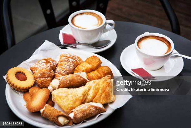 set table with traditional sweets and cappuccino coffee at  street cafe in florence, italy - powder puff stock pictures, royalty-free photos & images