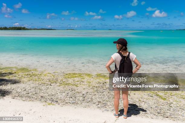 girl looking the sea on an amazing sunny day at one foot island in the lagoon of aitutaki - south pacific ocean stock pictures, royalty-free photos & images