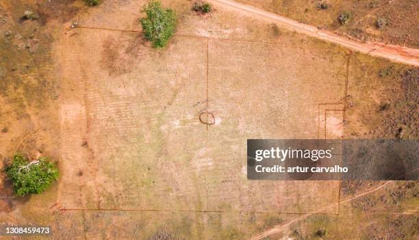 african dirt football pitch, soccer pitch from above - aerial football stock-fotos und bilder