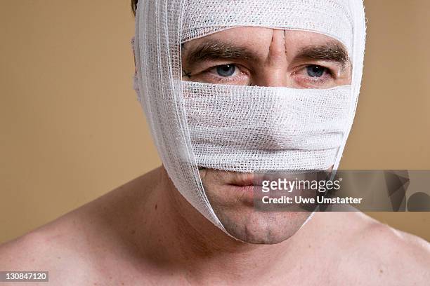 man with a bandaged face - plastic surgery stockfoto's en -beelden