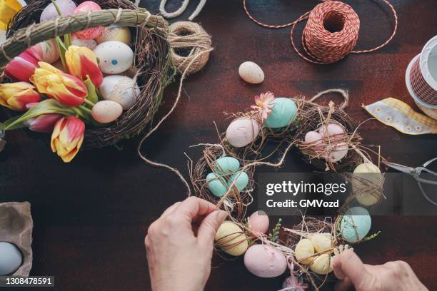 preparing easter wreath with easter eggs - easter wreath stock pictures, royalty-free photos & images