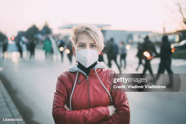 activist with arms crossed - mask confrontation stock pictures, royalty-free photos & images