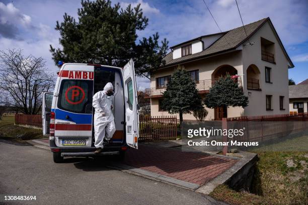 Bochnia Hospital paramedic exits the ambulance as he arrives to assist COVID- 19 patients under quarantine on March 22, 2021 in Bochnia, Poland. The...