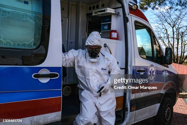 Bochnia Hospital paramedic exits the ambulance as he arrives to assist COVID- 19 patients under quarantine on March 22, 2021 in Bochnia, Poland. The...