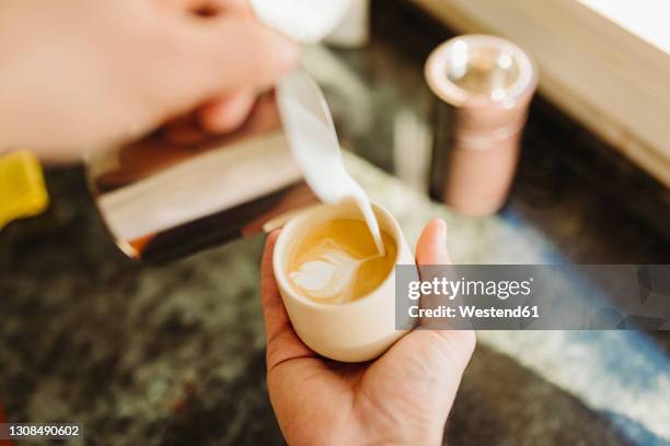 young man preparing latte in kitchen - personal perspective coffee stock pictures, royalty-free photos & images