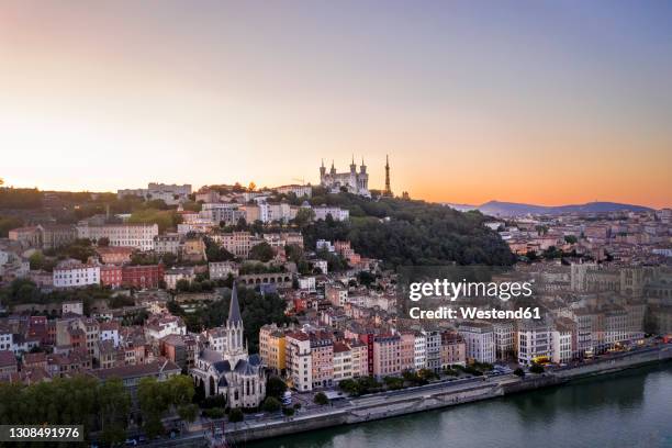 france, auvergne-rhone-alpes, lyon, aerial view of riverside city at dusk - lyon photos et images de collection