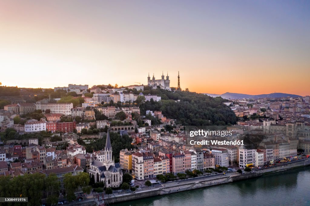 France, Auvergne-Rhone-Alpes, Lyon, Aerial view of riverside city at dusk