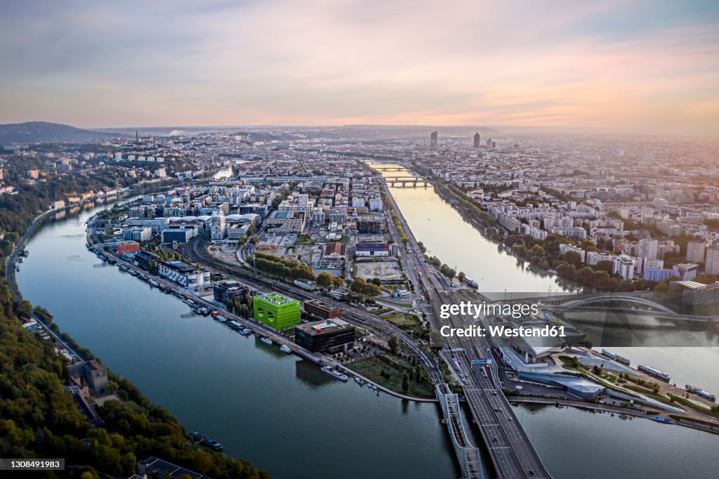 France, Auvergne-Rhone-Alpes, Lyon, Aerial view of city situated at confluence of Rhone and Saone rivers at dusk