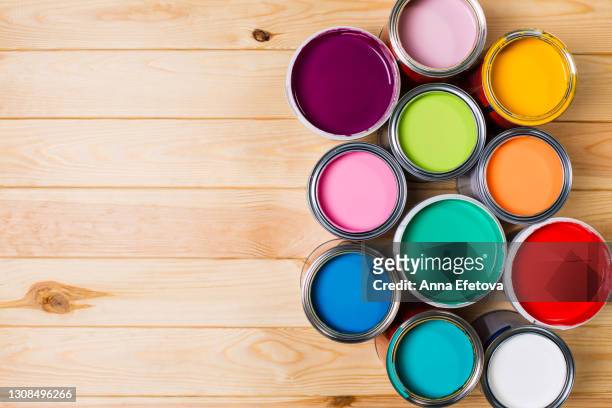 set of open metal buckets with bright multicolored paints ready for renovation works on timber floor. flat lay style. copy space for your design. concept of redecoration in home interior. color swatch for design ideas - painting art product stock pictures, royalty-free photos & images