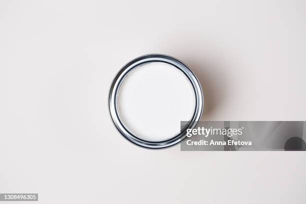 metal tin with white paint for renovation works on white background. flat lay style. copy space for your design. concept of redecoration in home interior. color swatch for design ideas - ペンキ缶 ストックフォトと画像