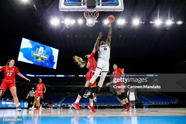Trinity Baptiste of the Arizona Wildcats drives to the basket ahead of Hailey Zeise of the Stony Brook Seawolves during the second half in the first...