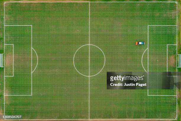 drone point of view over a community grass football pitch - sport venue stock pictures, royalty-free photos & images