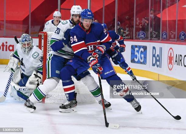 Corey Perry of the Montreal Canadiens controls the puck against Brandon Sutter of the Vancouver Canucks in the NHL game at the Bell Centre on March...