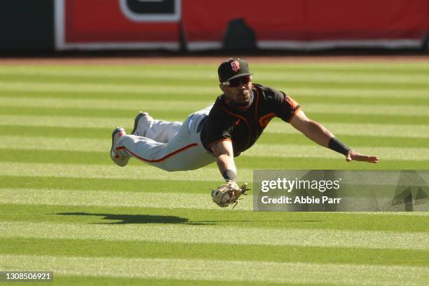 LaMonte Wade Jr. #31 of the San Francisco Giants makes a diving catch to record an out in the seventh inning against the Chicago White Sox during the...